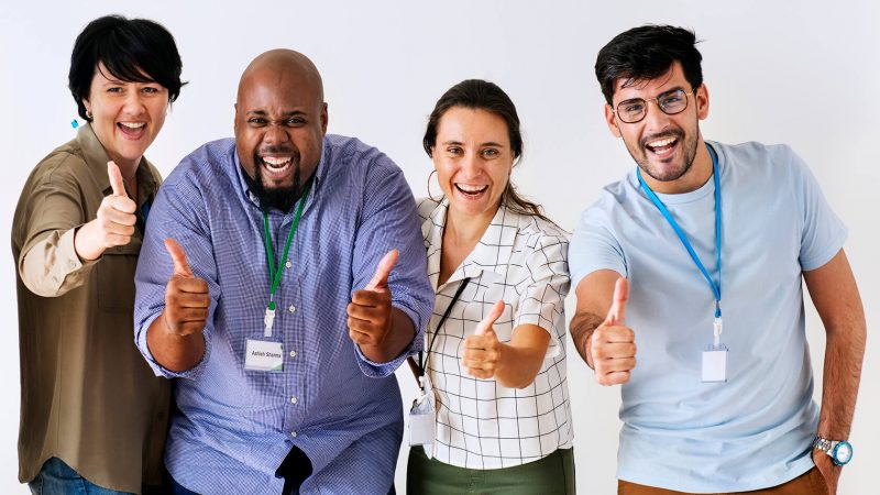 A group of people giving thumbs up to the camera.