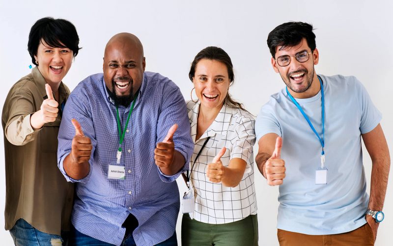 A group of people giving thumbs up to the camera.