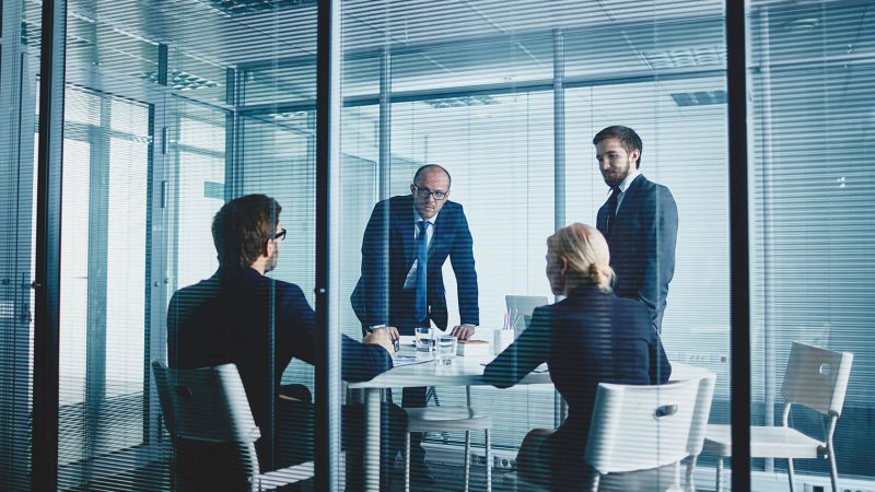 A group of people sitting around a table.